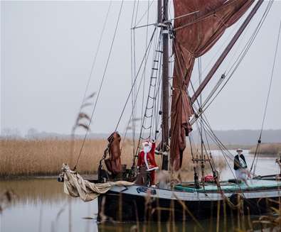 Father Christmas sails into Snape Quay