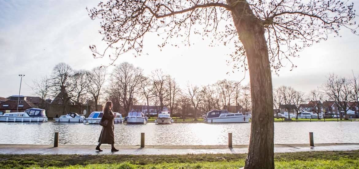 Woman walking along the river at Beccles - Emily Fae Photography