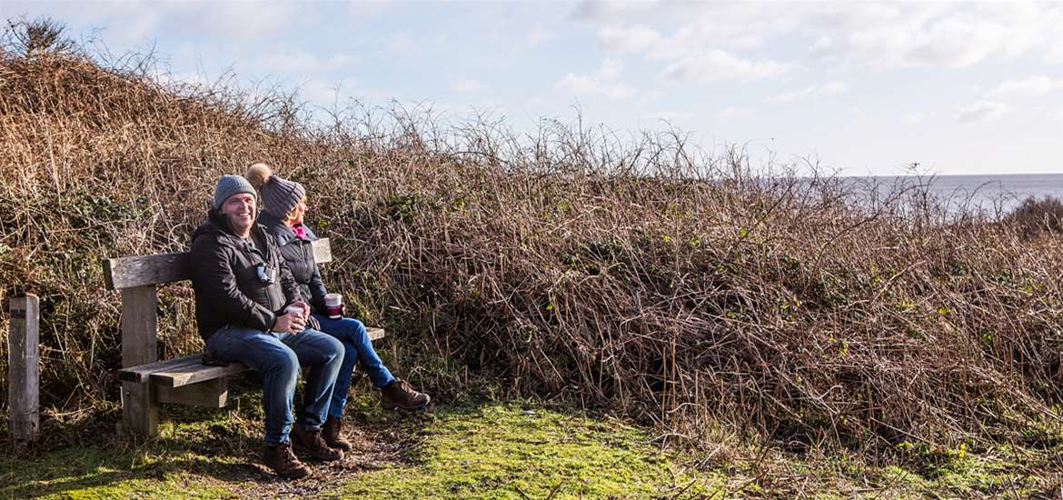 Couple sitting on bench at Dunwich
