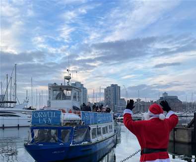 Father Christmas waving people off the Orwell Lady