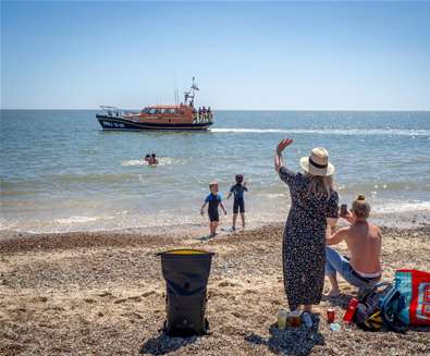Children waving at Lifeboat on Lowestoft beach (c) Gavin Butler