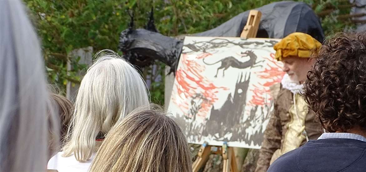 Black Shuck Festival - Man in period costume with a painting of the Black Shuck