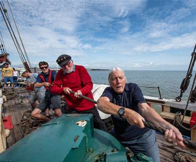 TTDA - Excelsior - Men on boat