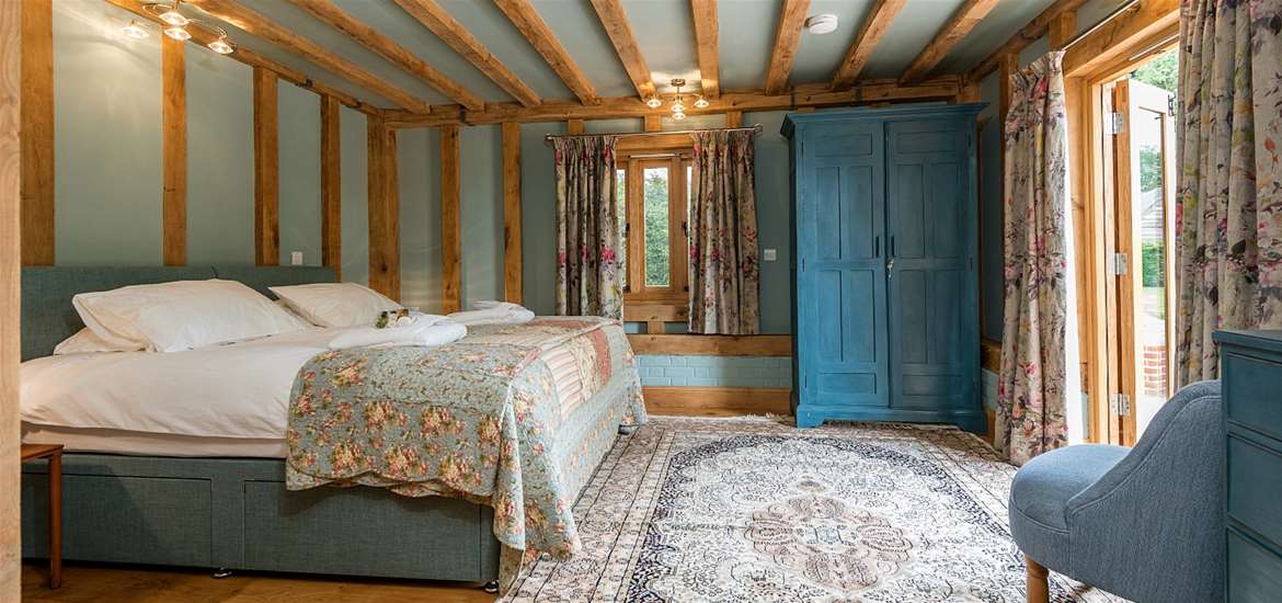 Where to Stay - Corner Farm Holidays - Bedroom with beams