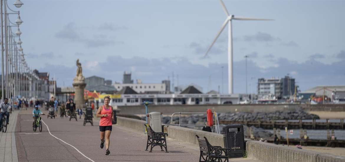 Woman running along the promenade at Lowestoft