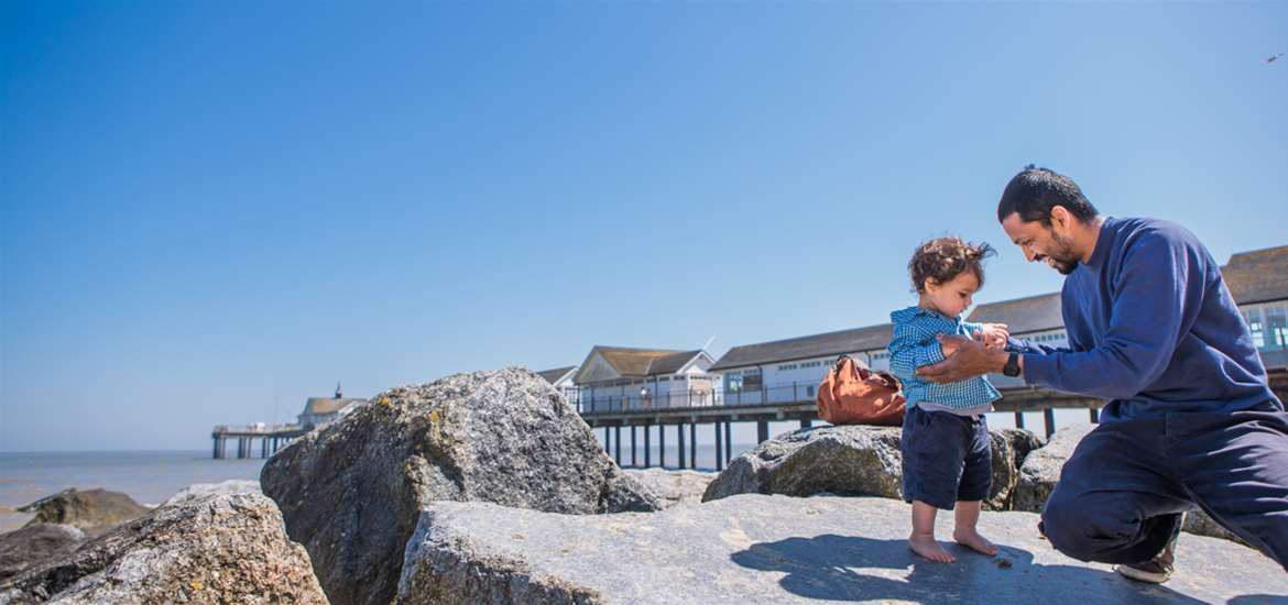 Child and father on beach at Southwold