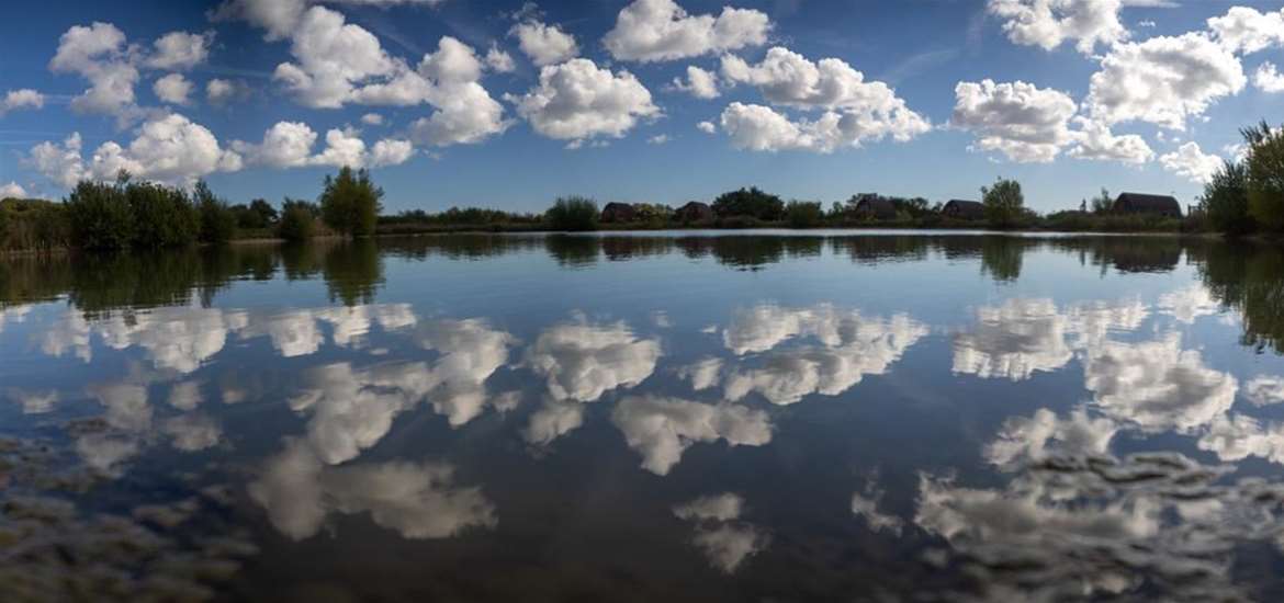 Mirror Finish on Kingfisherlake with camping pods in the background